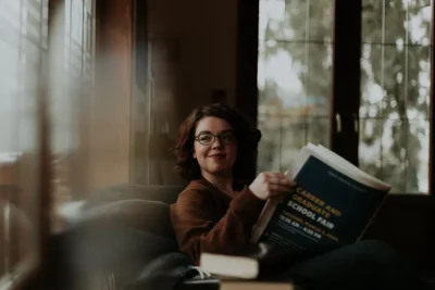 Young woman reading on her sofa