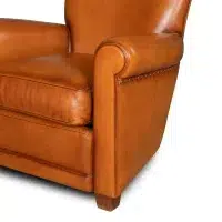 Honey Gaston leather club chair zoom on an armrest