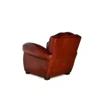 Cognac Petit Moustache leather club chair in 3/4 back view